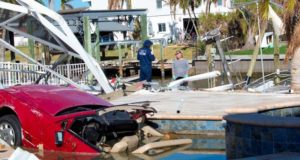 A U.S. Coast Guard member surveys hurricane damage.