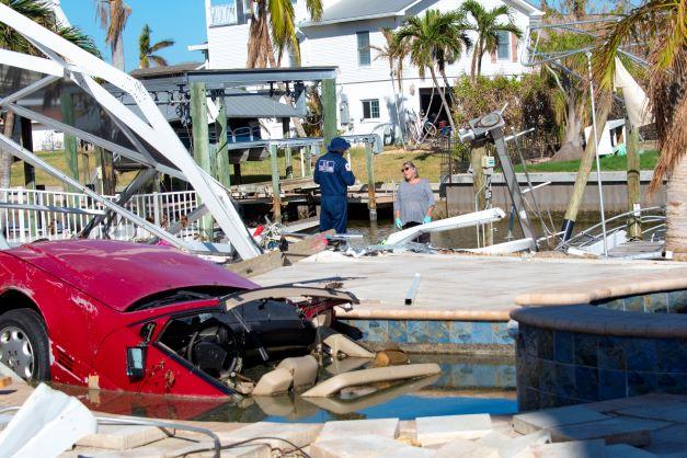 A U.S. Coast Guard member surveys hurricane damage.