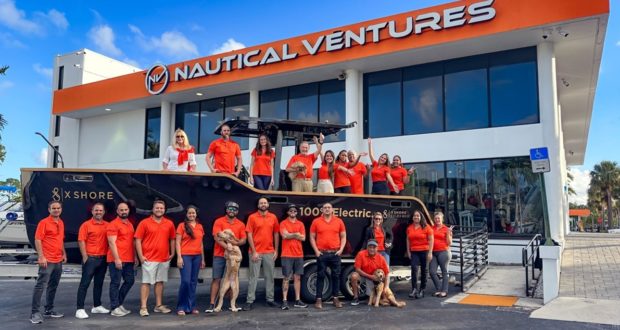 Nautical Ventures team poses with a new model from X-Shore Boats.