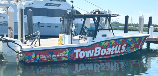 TowBoatUS Autism Awareness boat on the water.